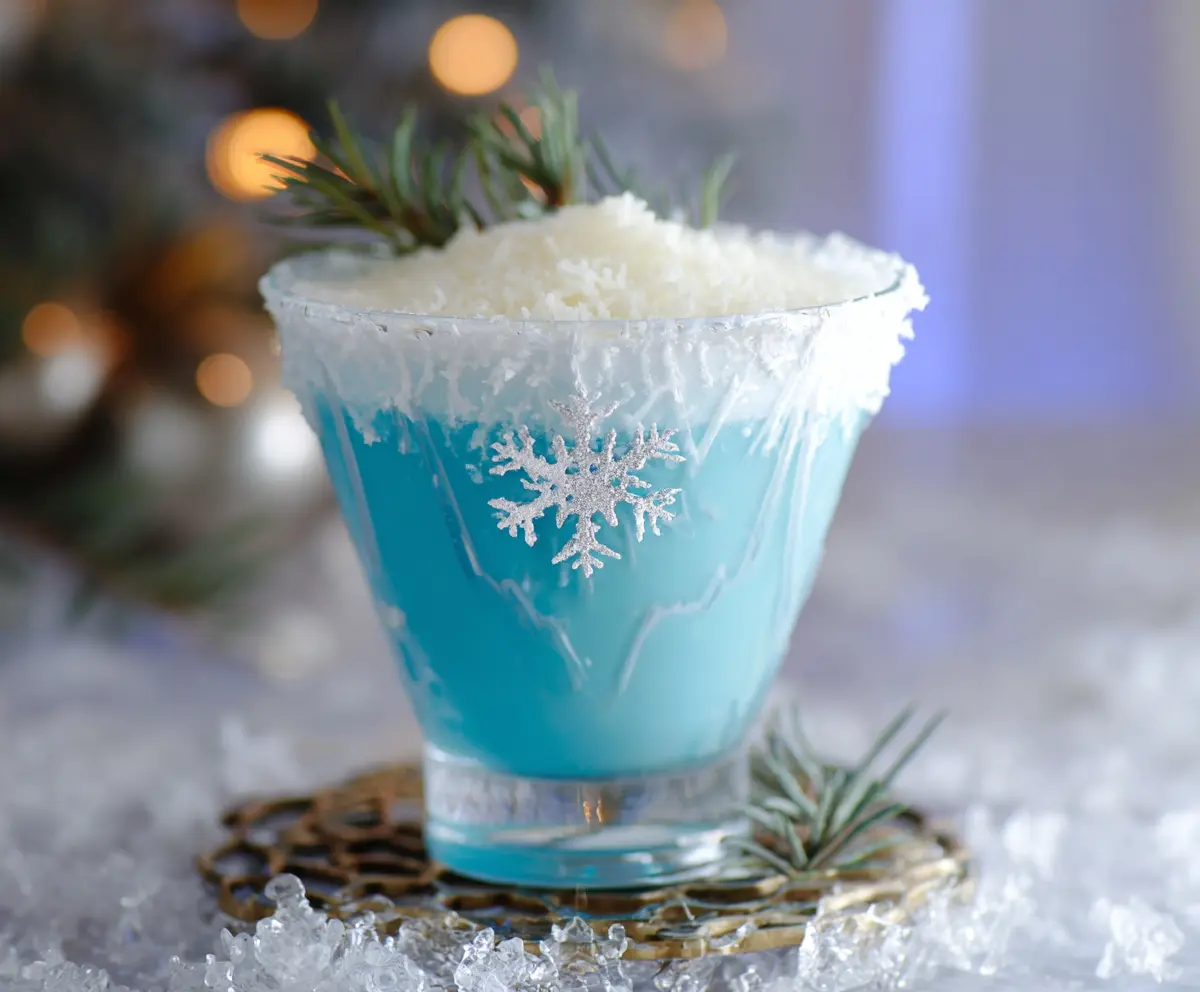 Festive Christmas Snowflake Cocktail with icy blue garnish and holiday decorations