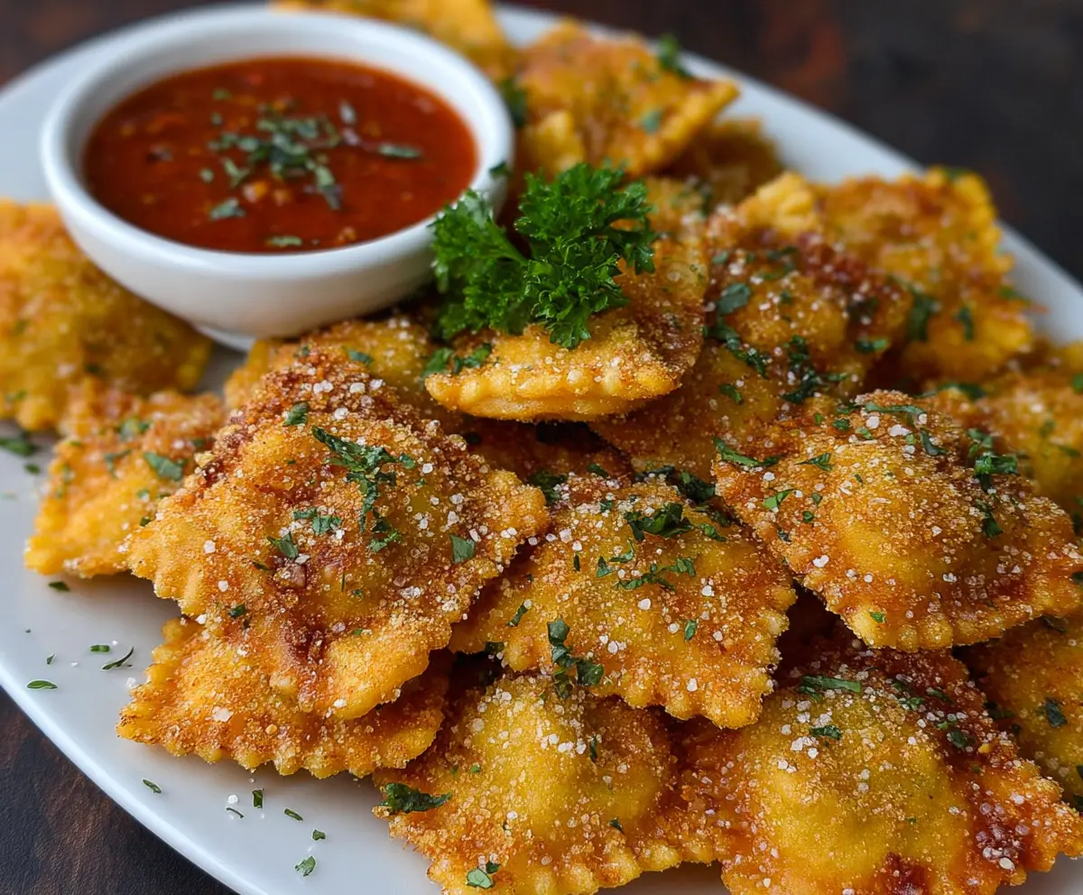 Crispy fried ravioli served with marinara sauce for a delicious appetizer.