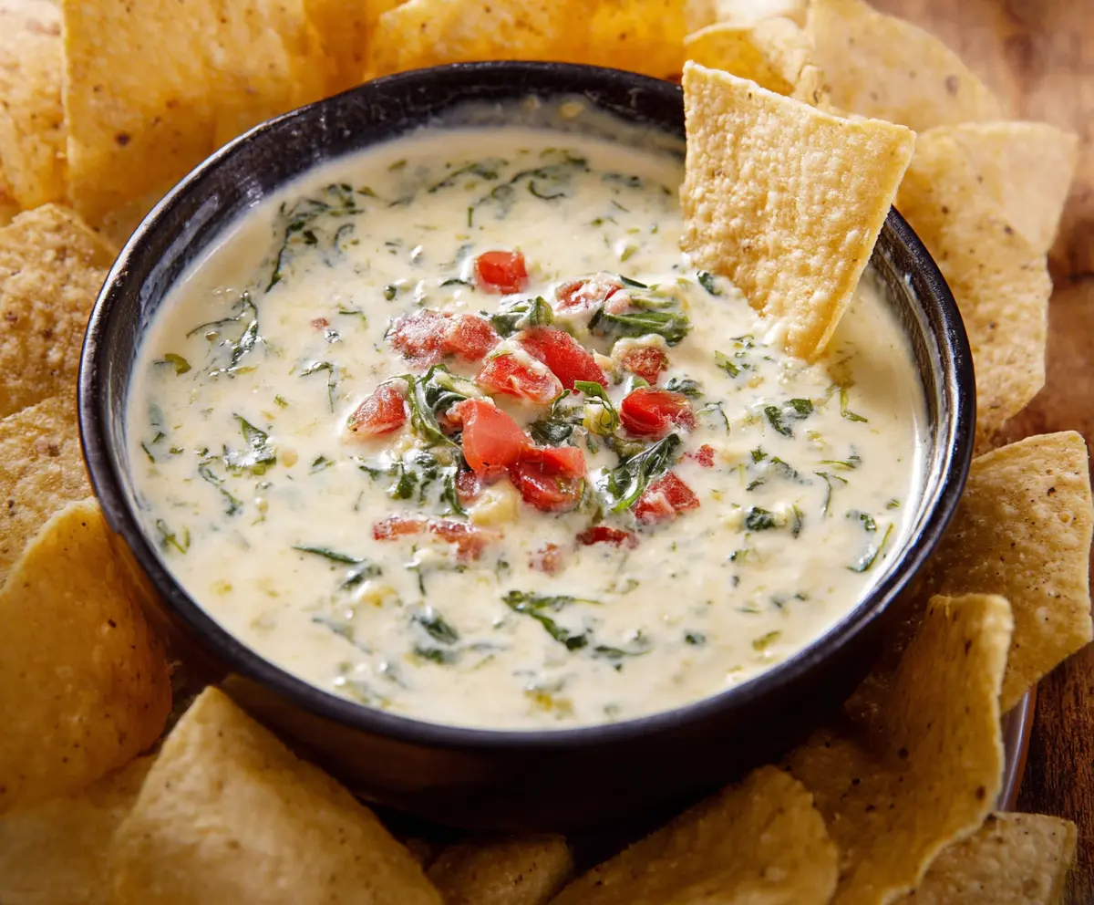 Creamy White Spinach Queso served in a bowl, perfect for dipping or topping nachos.