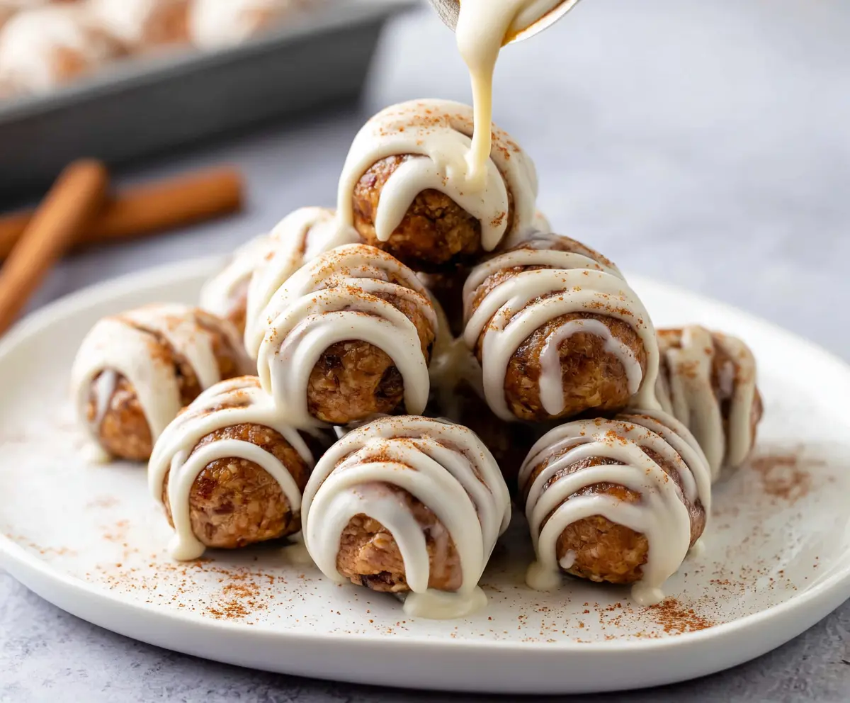 Delicious Cinnamon Roll Protein Bites with frosting on a plate, perfect for a healthy snack.