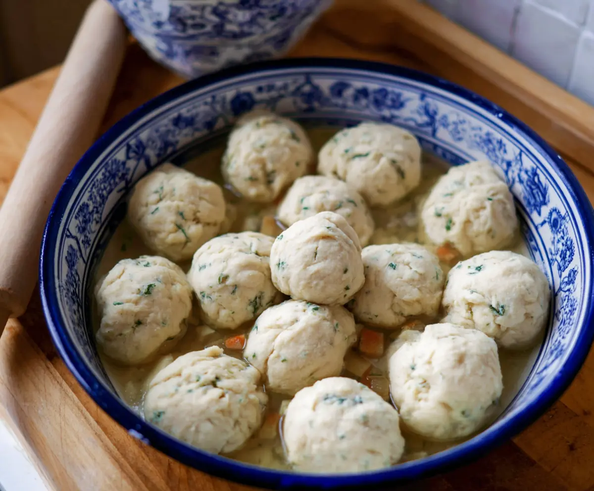 Delicious sourdough discard dumplings served with herbs on a rustic plate