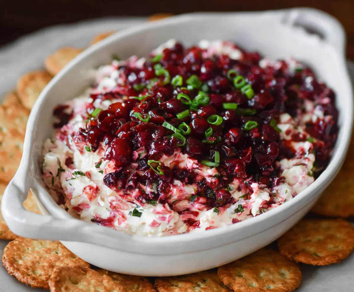 Creamy Cranberry Jalapeno Dip with Fresh Cranberries and Spicy Jalapenos in a white bowl.