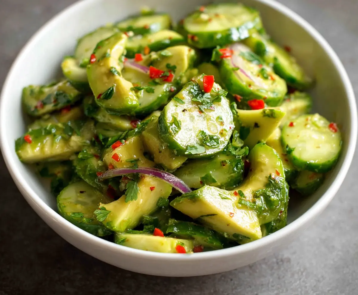 Fresh cucumber and creamy avocado salad with herbs, perfect for a healthy meal.