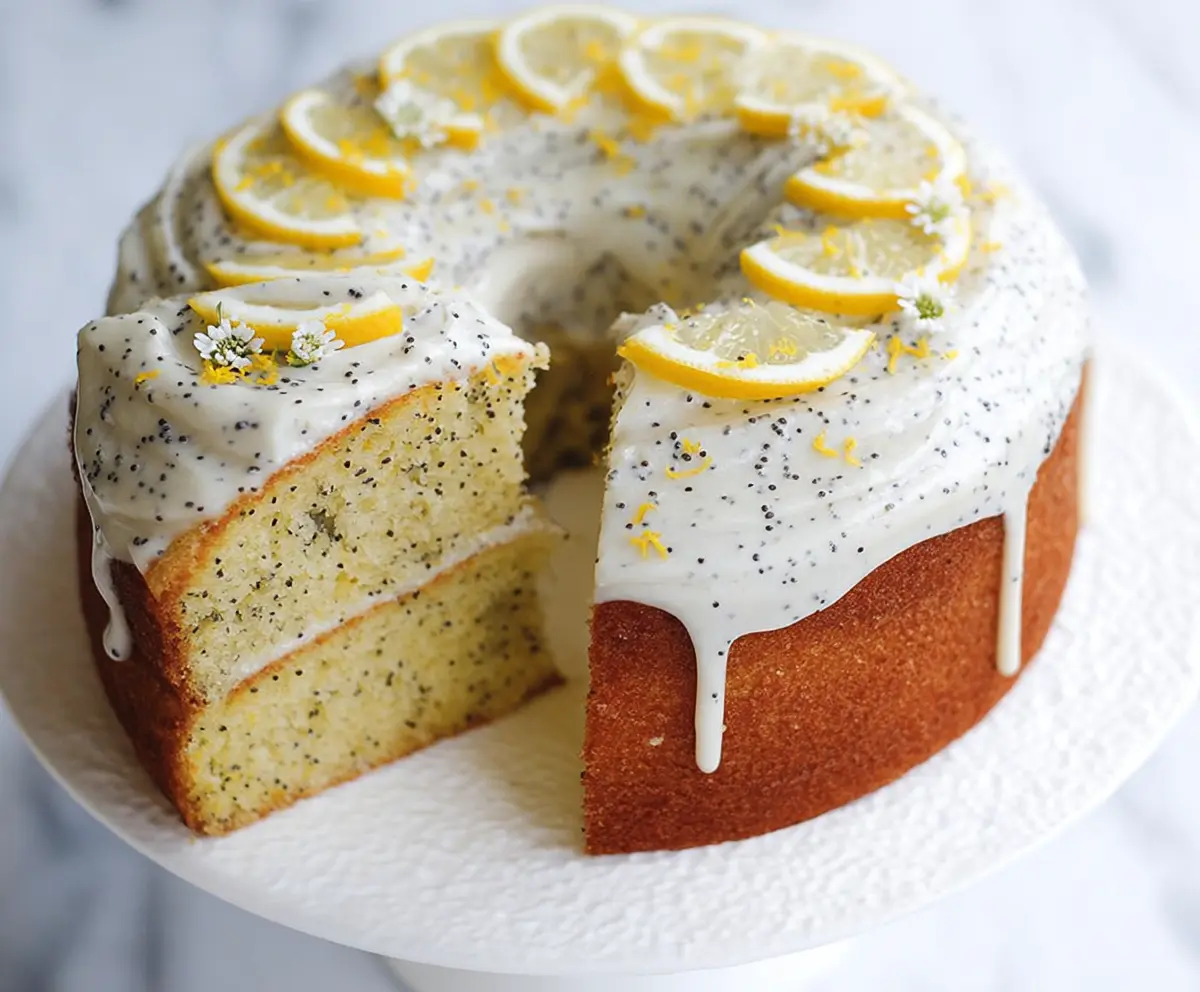 Delicious lemon poppy seed cake on a plate with lemon slices and mint garnish